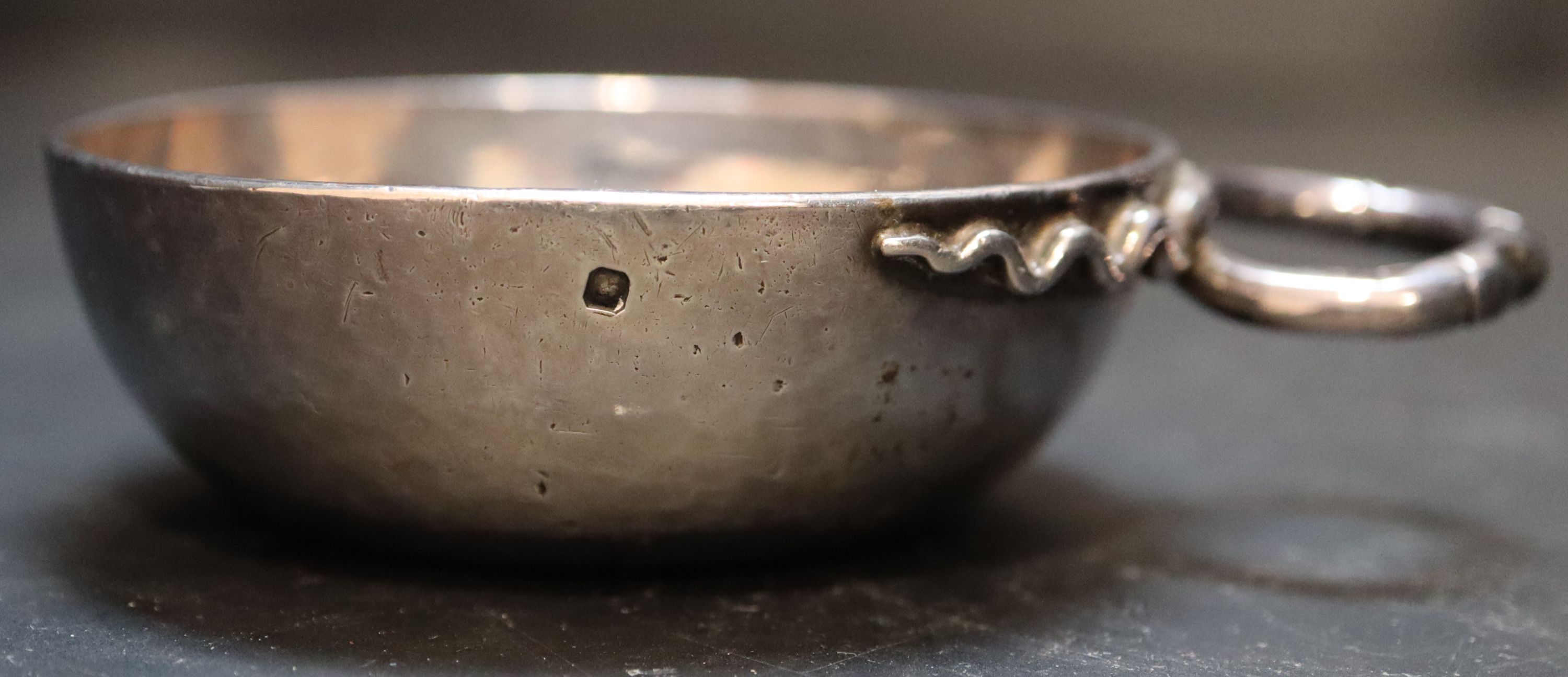 A 19th century French white metal wine taster, diameter 7.6cm, 3.5oz.